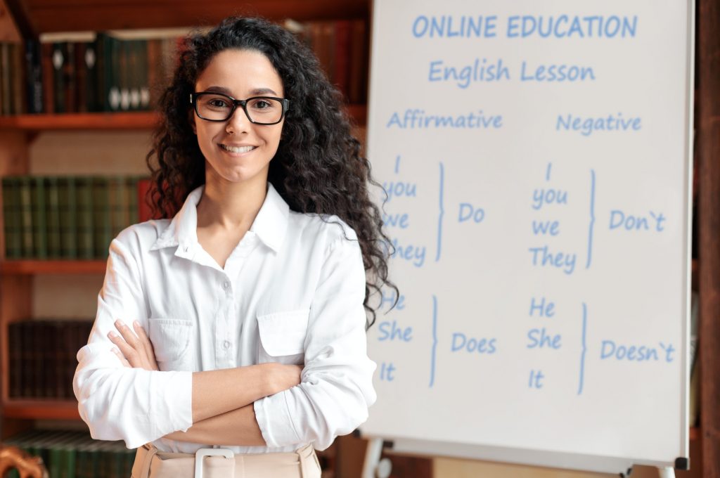 english-teacher-standing-at-board-posing-at-camera.jpg english-teacher-standing-at-board-posing-at-camera.jpg